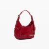 Kleine glänzende Tasche mit Blumen-Applikationen