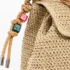 Kleiner Raffia-Rucksack mit Anhängern Kleiner Raffia-Rucksack mit Anhängern